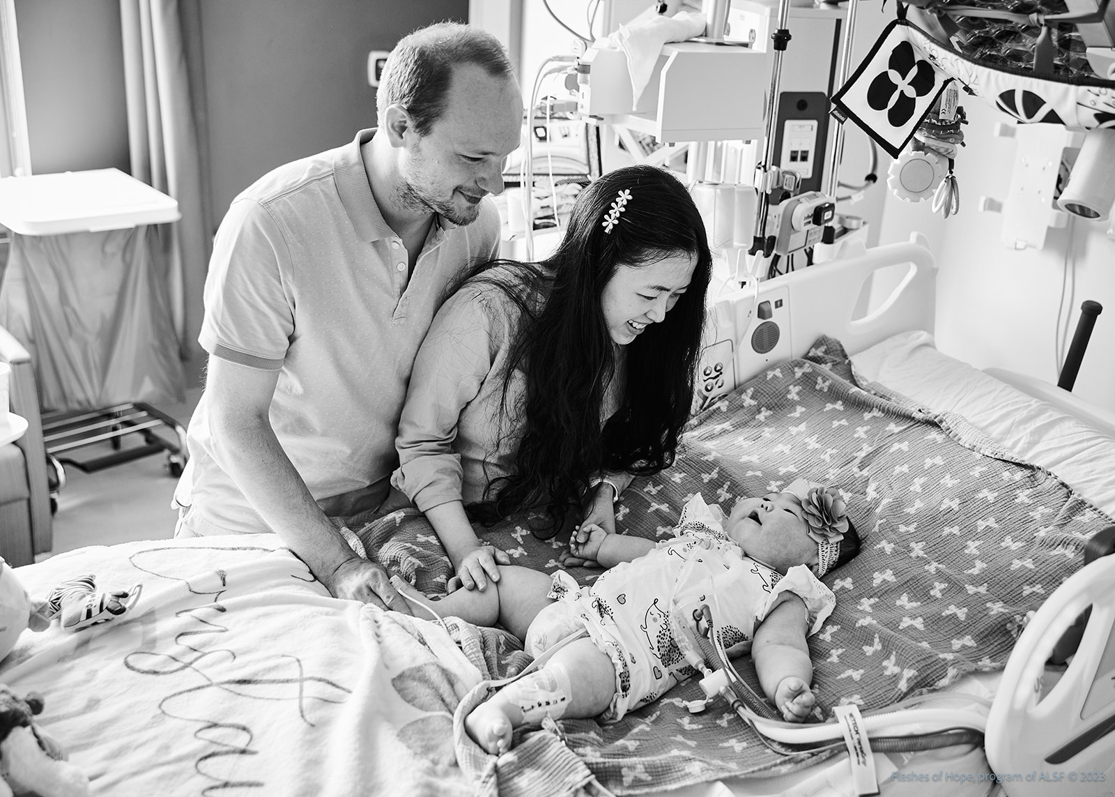 Black and white of Mommy and Daddy at Constance's bedside